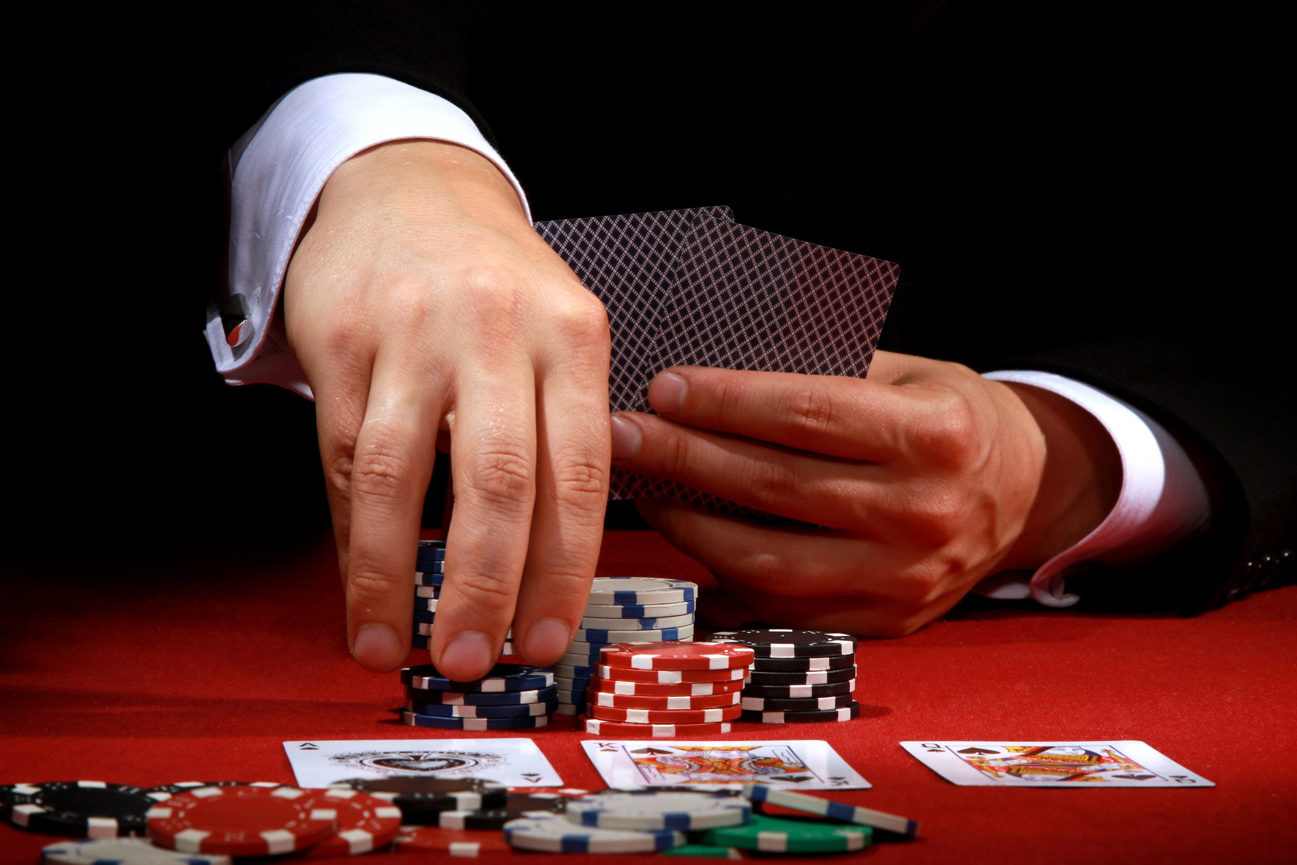 closeup-of-male-hands-playing-poker-2023-02-01-07-06-17-utc-scaled.jpeg